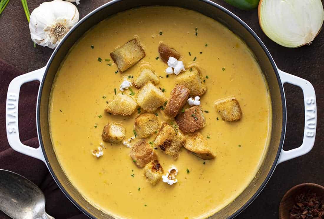 Beer Cheese Soup combines beer with lots of sharp cheddar cheese, chicken stock, half and half, and plenty of vegetables for a creamy and delicious soup. Beer Cheese Soup, Beer Soup, Soup, Soup Recipes, Easy Soup, Cheesy Soup, i am homesteader, iamhomesteader, fall soups, thanksgiving, Christmas Overhead of Beer Cheese Soup in Pot
