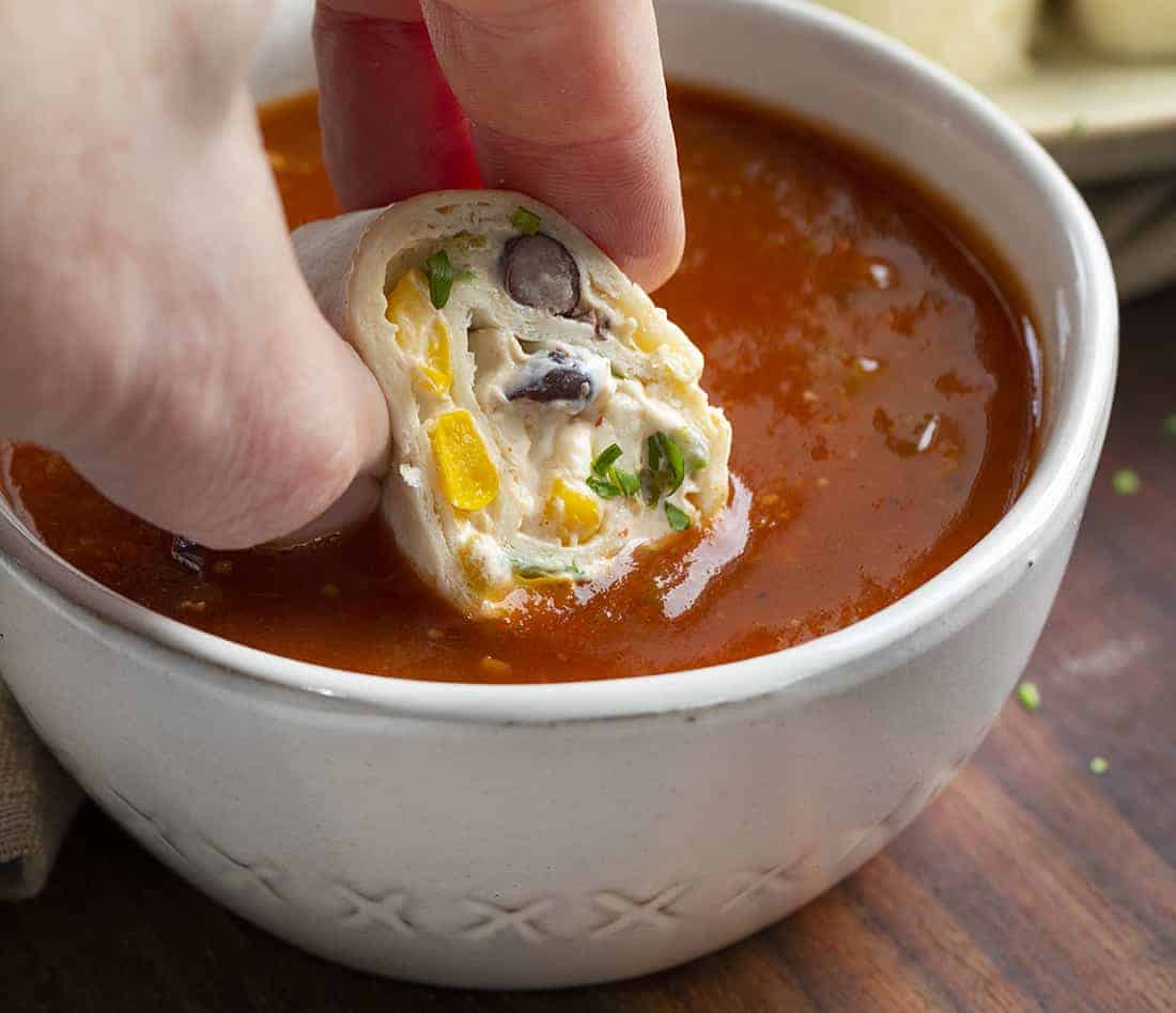 Mexican inspired Tortilla Pinwheels are flour tortillas that are wrapped around a cheesy mixture loaded with chiles, green onions, black beans, corn, jalapeno peppers, and taco seasoning. Tortilla Pinwheels, Mexican Pinwheels, Pinwheel Recipes, Appetizers, i am homesteader, iamhomesteader, recipes Tortilla Pinwheels Dipped in Salsa