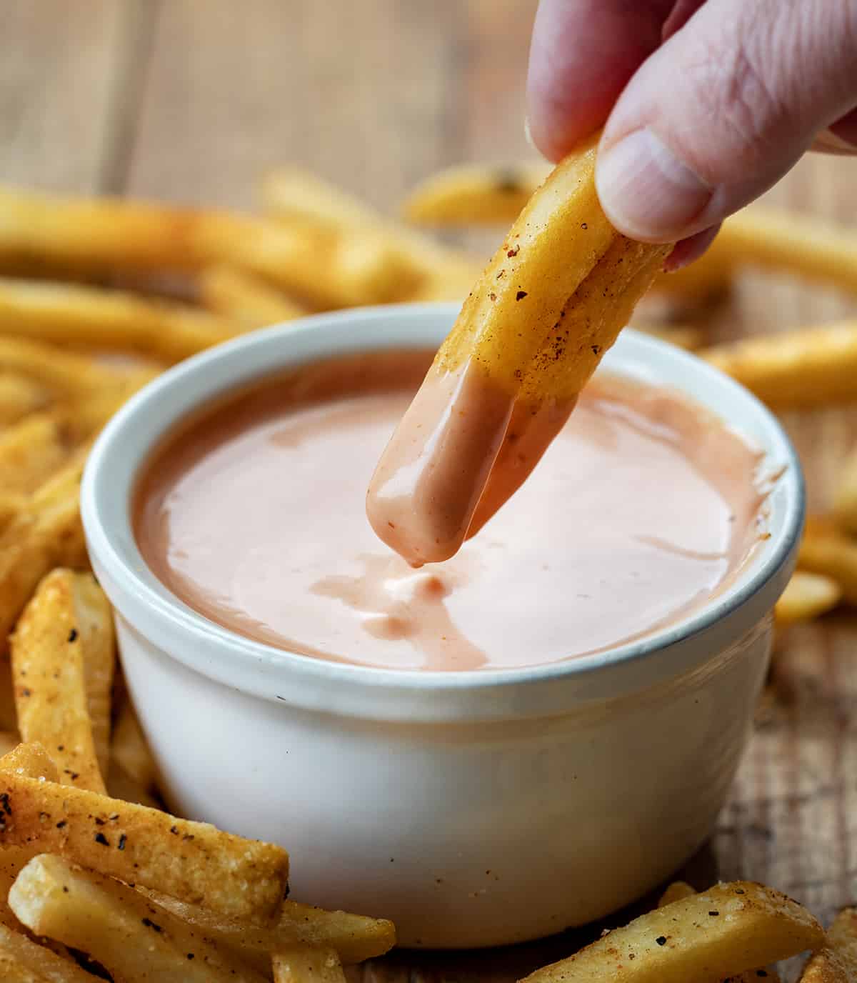 Dipping French Fries into Easy Fry Sauce.