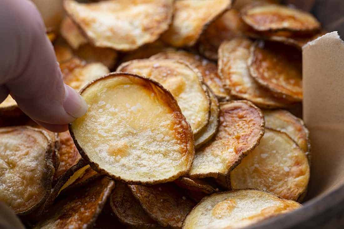 Hand Picking up Potato Chips