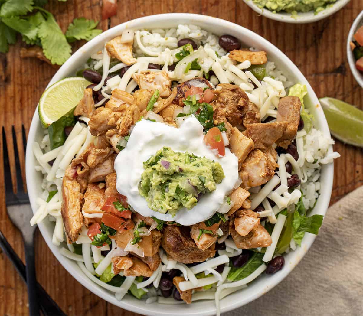 Overhead image of a Chicken Burrito Bowl {Chipotle Copycat} in a white bowl on a Cutting Board