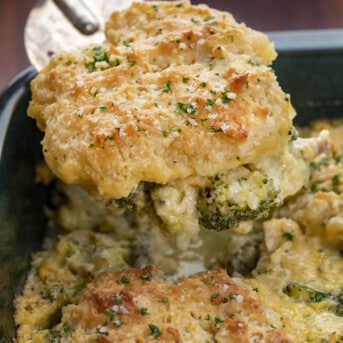 Spatula Picking up One Biscuit Biscuit Broccoli Cheddar Casserole. Dinner, Supper, Dinner Recipes, Broccoli Cheese Casserole, 5 Star Broccoli Cheese Casserole, Broccoli Cheese Casserole with Chicken, Biscuits Broccoli Cheese Casserole, Broccoli Cheese Casserole without Rice, Cheesy Biscuit Broccoli Casserole, recipes, comfort food, i am homesteader, iamhomesteader