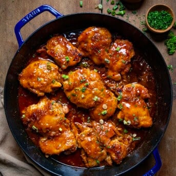 Pan of Firecracker Chicken on a wooden table from overhead.