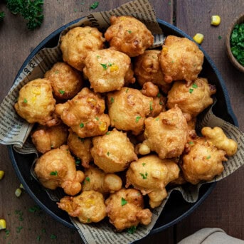 Skillet of Corn Nuggets on a wooden table from overhead.