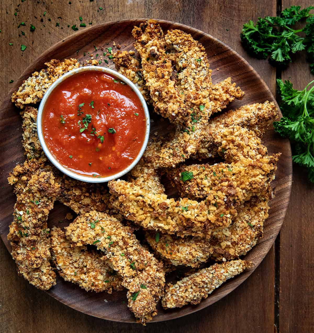 Satisfy your snack cravings with these delicious Portobello Mushroom Fries. A crispy, flavorful appetizer that's perfect for sharing or enjoying on your own! Plate of Portobello Mushroom Fries on a wooden table from overhead.