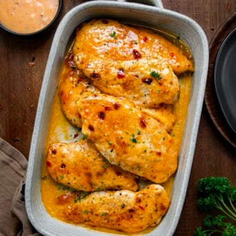 Bang Bang Chicken Bake on a wooden table with bang bang sauce from overhead.