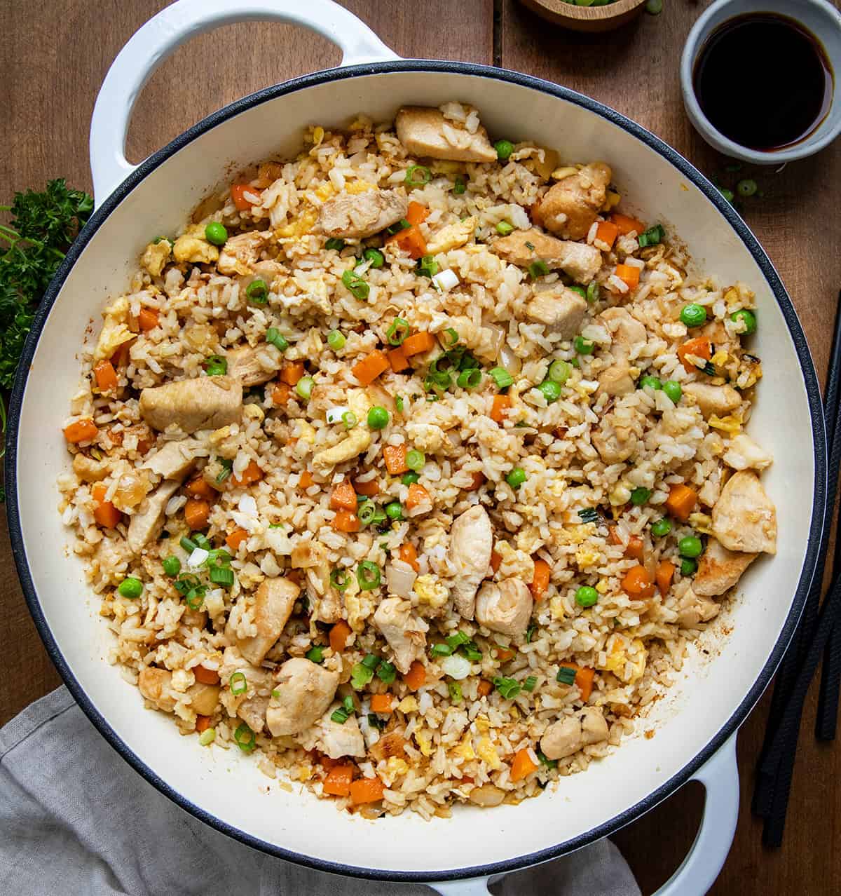 If you are craving a homemade, restaurant-style dish that’s both flavorful and filling, this easy Chicken Fried Rice recipe is the perfect solution! With tender chicken, colorful vegetables, and perfectly fried rice, it’s a quick meal that’s ready in under 40 minutes. Skillet of Chicken Fried Rice on a wooden table from voerhead.